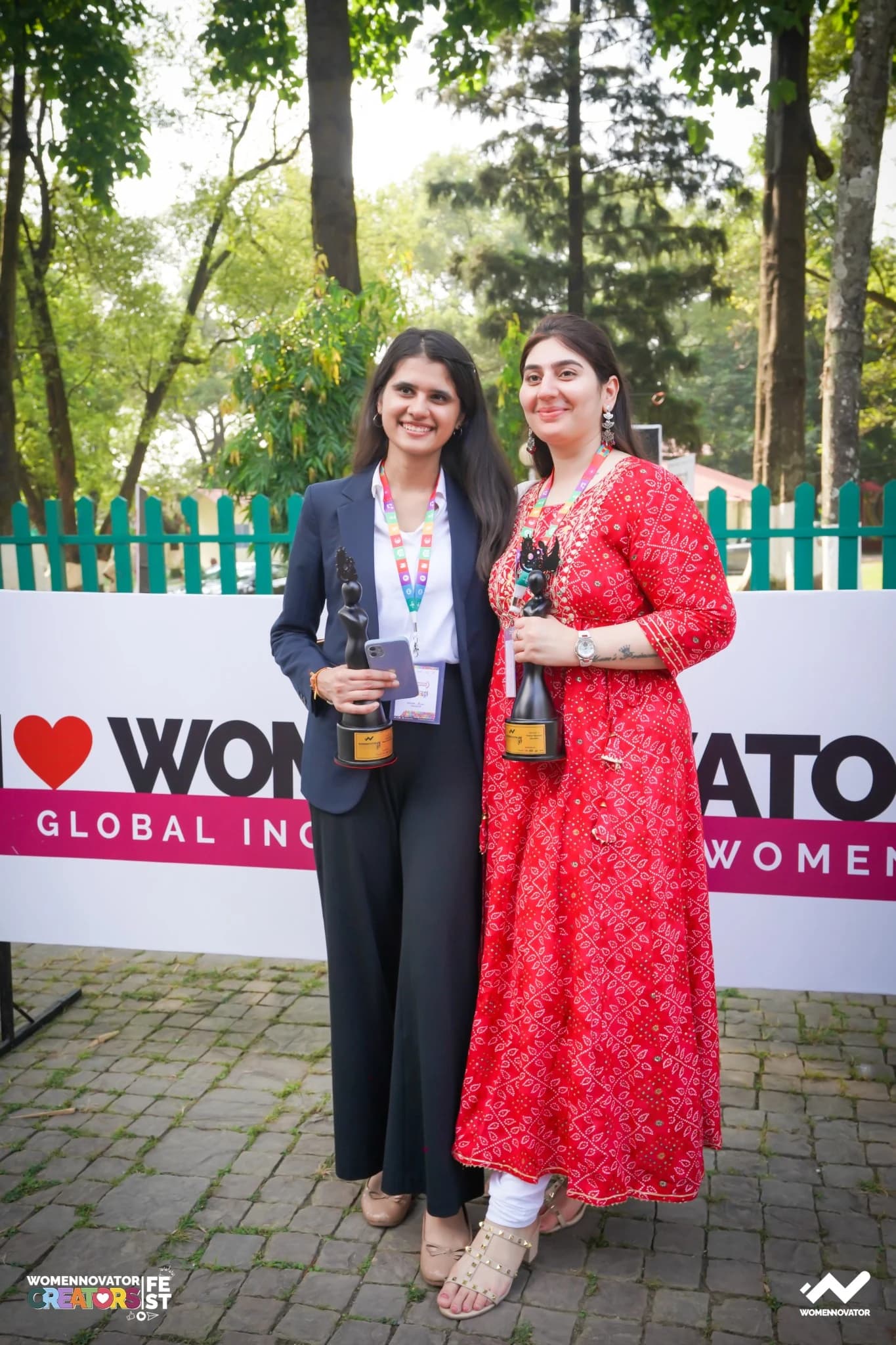 Two Womennovator event participants holding awards.