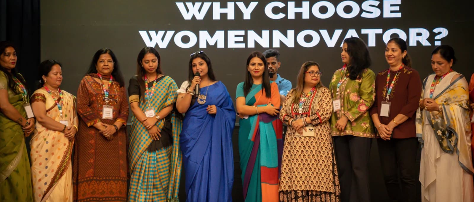Women speaking on stage at a Womennovator gathering
